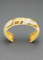 Front-facing view of the cream and gold Vintage Zebra Stripe Enamel Cuff Bracelet against a gray background.