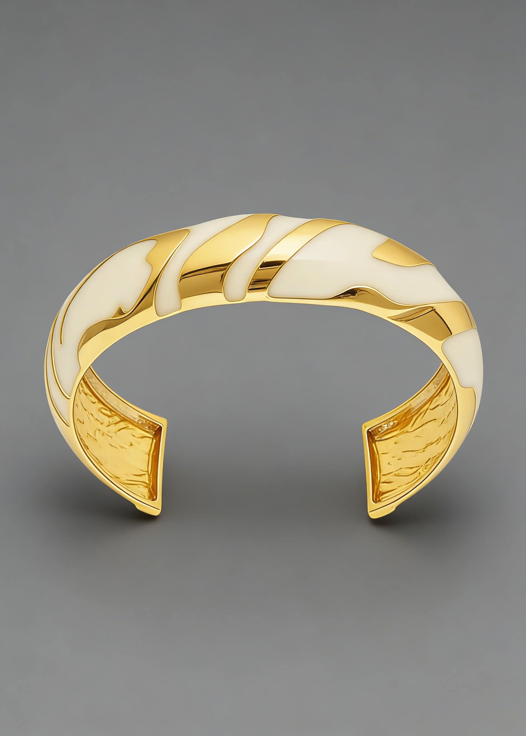 Front-facing view of the cream and gold Vintage Zebra Stripe Enamel Cuff Bracelet against a gray background.
