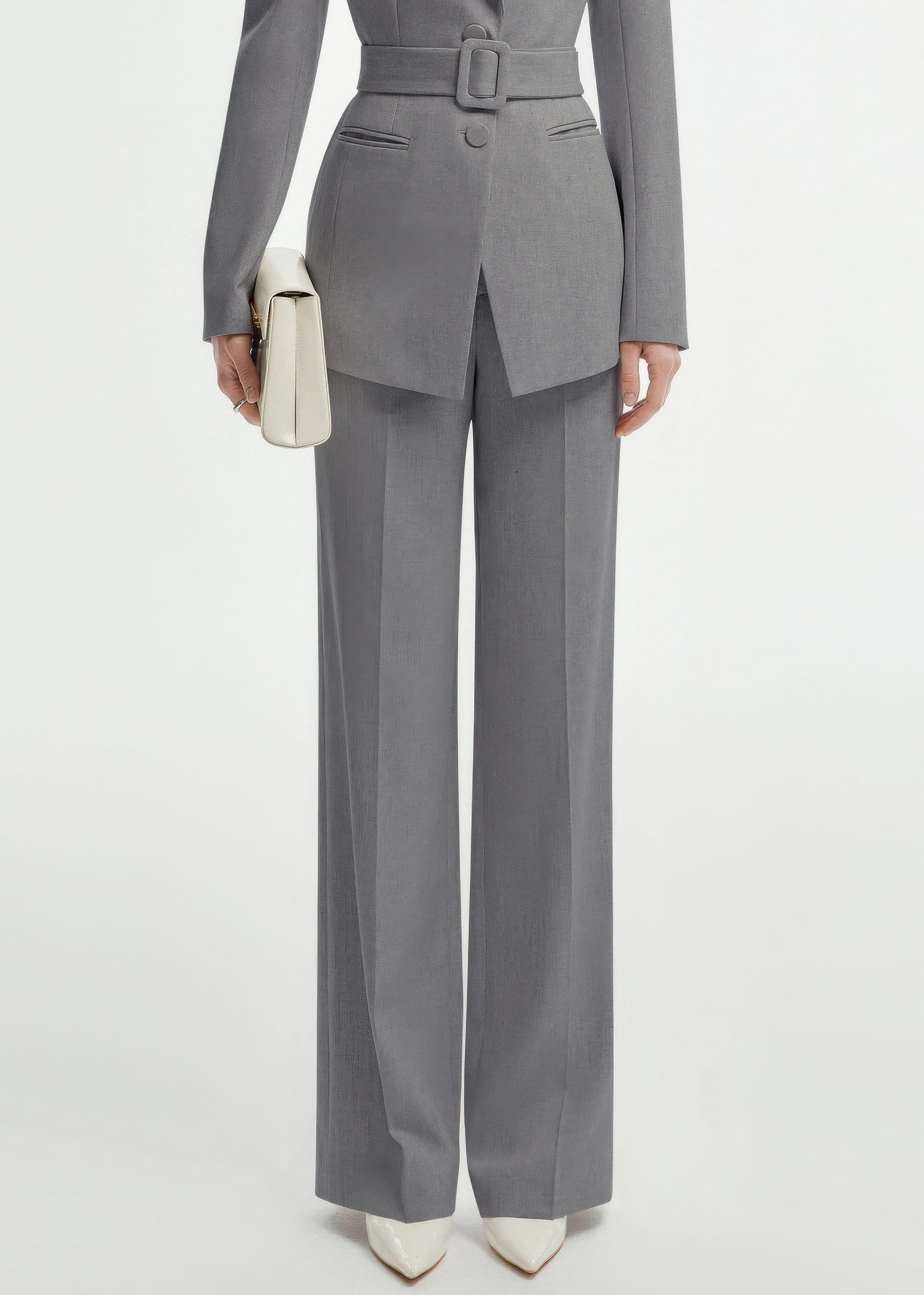 Lower-body shot focusing on the high-waisted, wide-leg grey trousers and the buckle detail of the suit's belt.