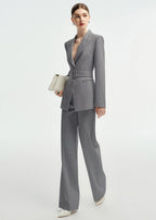 Side profile view of the grey belted suit, highlighting the structured shoulders and tailored fit.