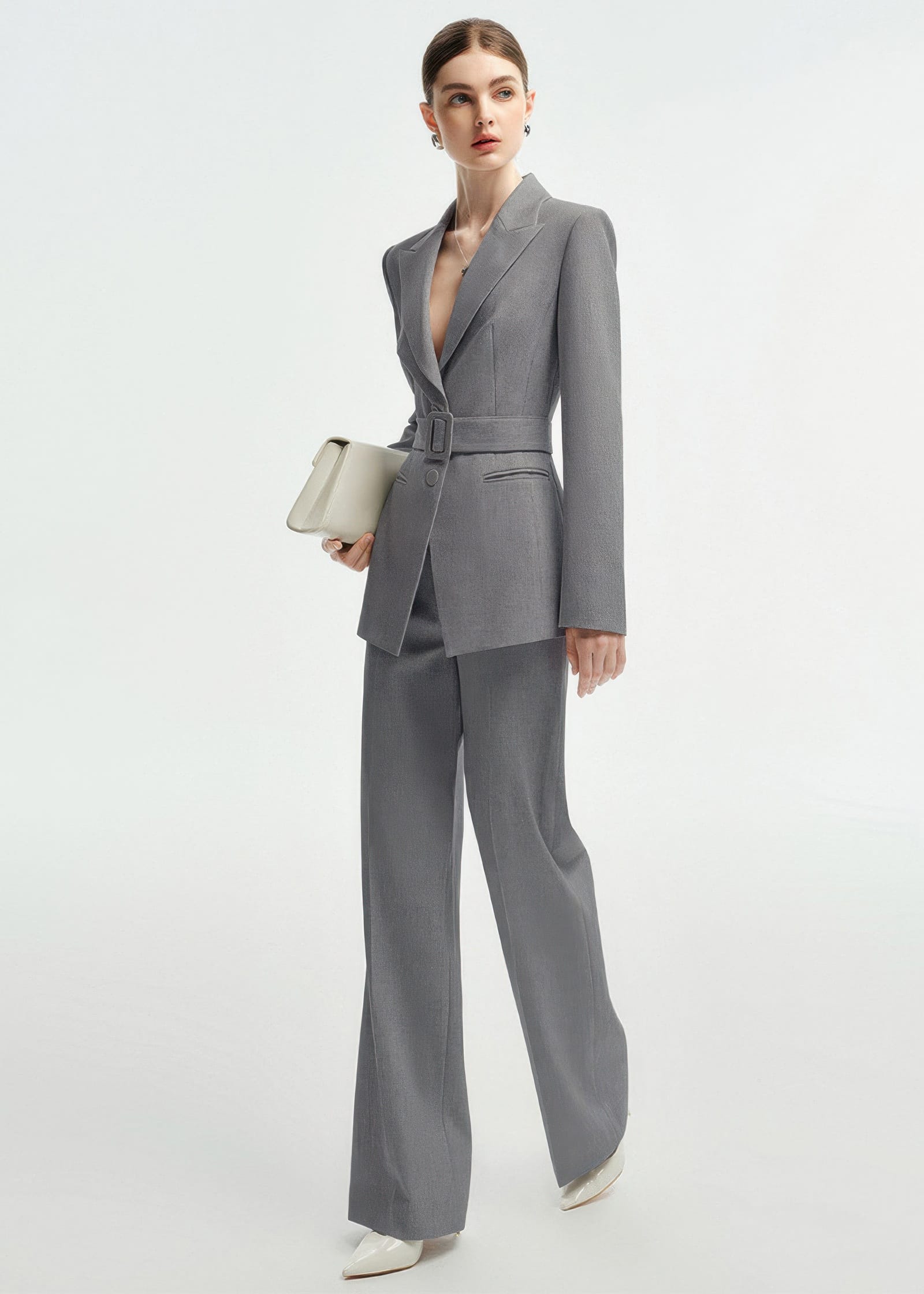Side profile view of the grey belted suit, highlighting the structured shoulders and tailored fit.