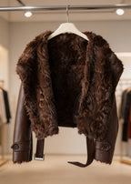  Interior detail view showing the plush brown faux fur lining and wide lapel of a winter aviator jacket.