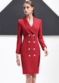 A woman walking forward wearing a structured red shawl lapel blazer dress.