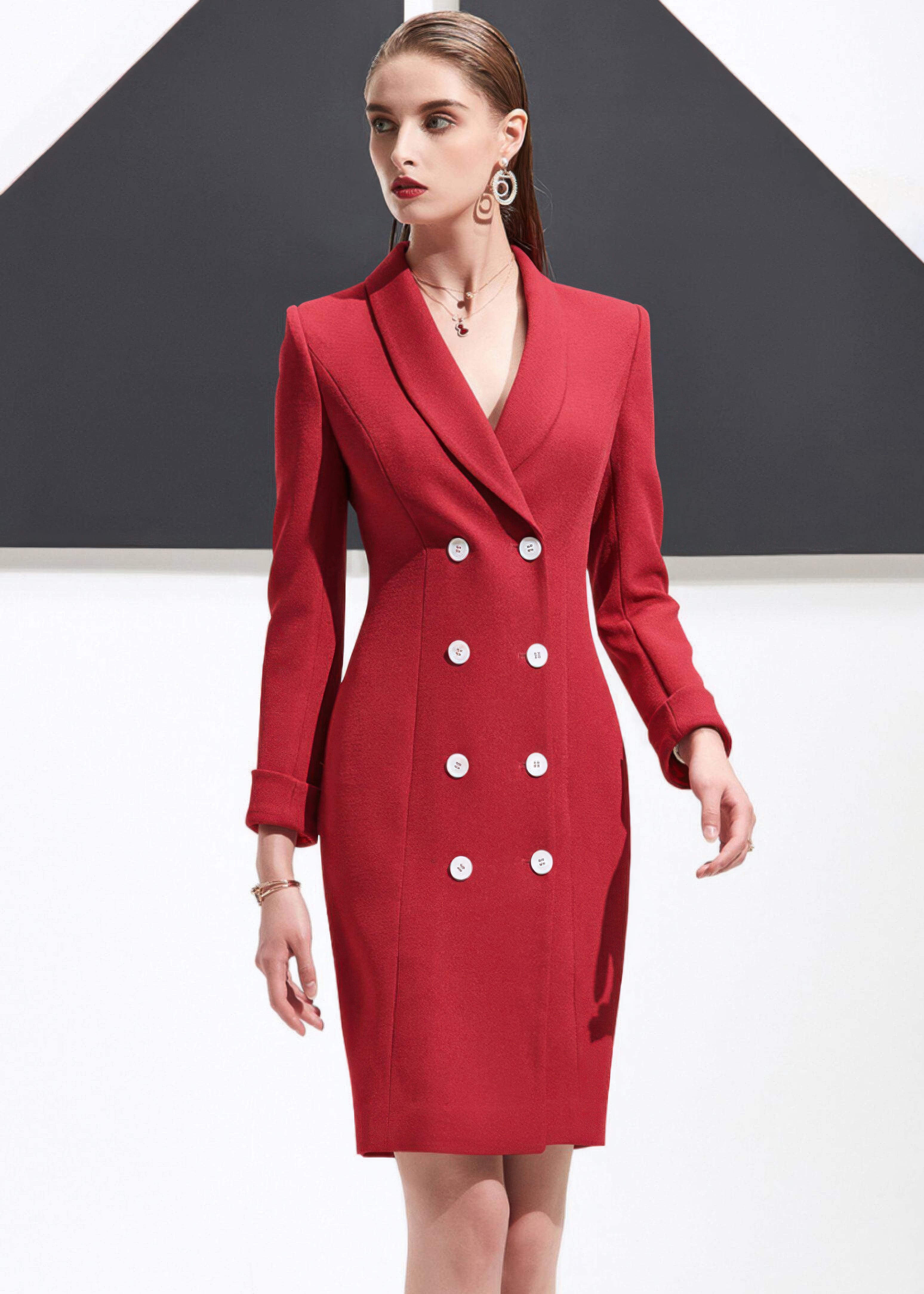 A woman walking forward wearing a structured red shawl lapel blazer dress.