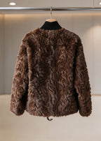 Back view of a dark brown plush faux fur coat displayed on a wooden hanger.
