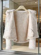 Inside lining and interior pocket detail of a women's cream fleece winter jacket