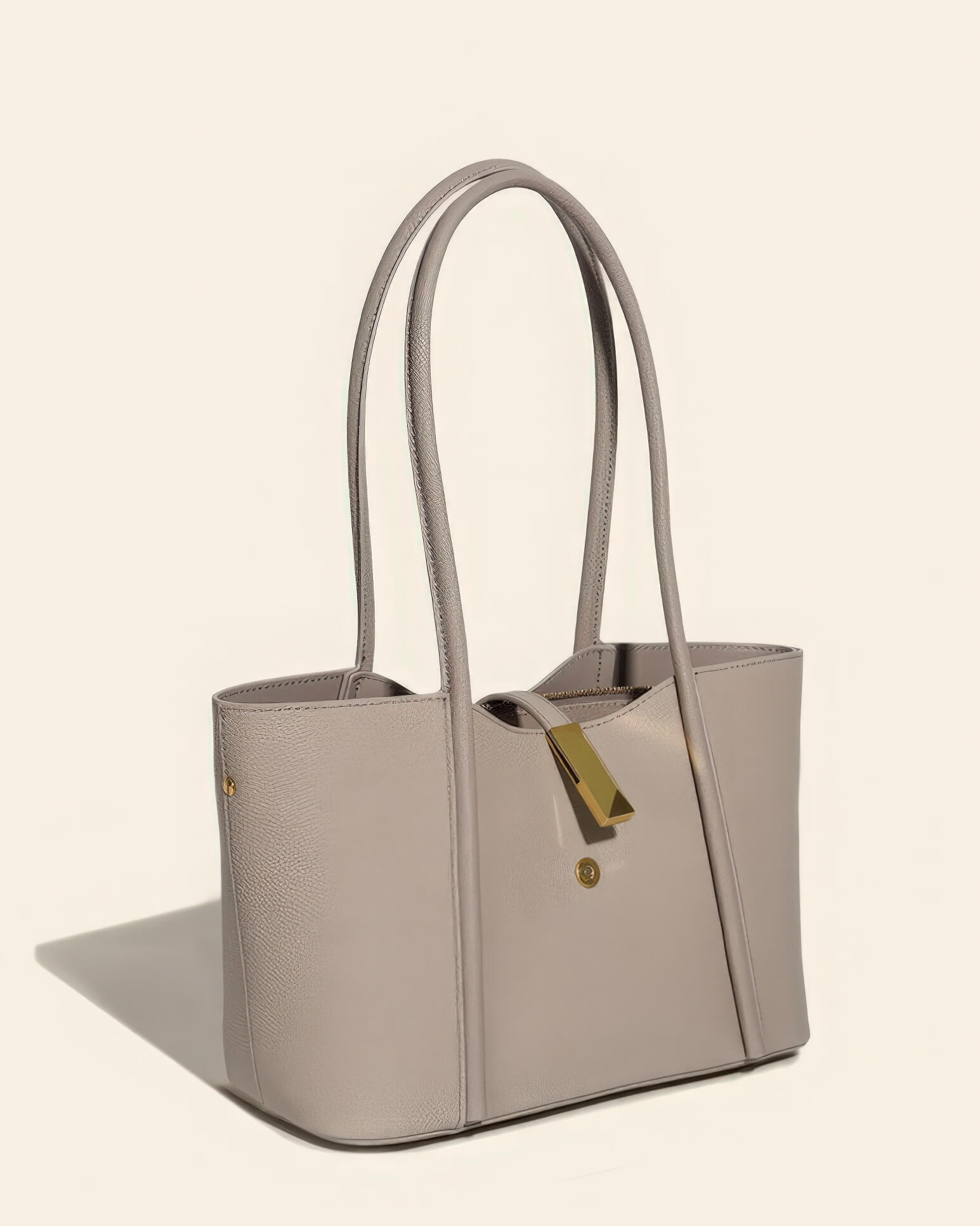 Close-up of the interior zip pocket and smooth lining of a high-quality grey leather work bag for women.