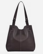 Top-down view of an open burgundy leather handbag showcasing its large storage capacity.