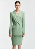 A front-facing, medium shot of the model wearing the mint green blazer, highlighting the double-breasted button detail, lapels, and pearl necklace.