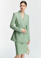 A close-up shot of the blazer's midsection and the model's hand, emphasizing the fabric texture and the flap pocket details.